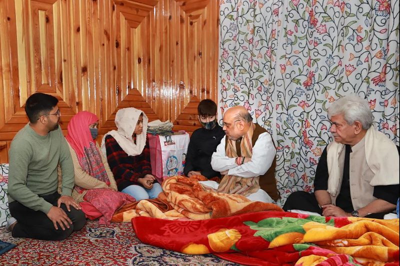 Nowgam: Union Home Minister Amit Shah visits the residence of martyr J&K Police, Inspector Parvez Ahmed who was killed by terrorists last month, and met his wife Fatima Akhter in Nowgam, Saturday, Oct. 23, 2021. HM has given government job to Parvez’s wife. (PTI Photo)