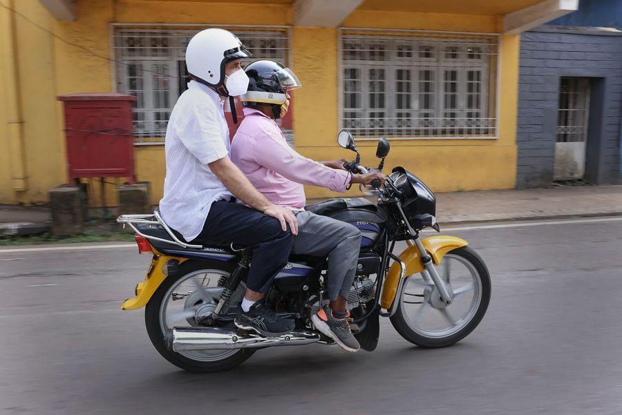 **EDS: HANDOUT PHOTO MADE AVAILABLE FROM AICC ON SATURDAY, OCT. 30, 2021** Panaji: Congress leader Rahul Gandhi takes a ride on Goa's motorcycle taxi known as 'Pilot', from Bambolim to Azad Maidan in Panaji. (PTI Photo)