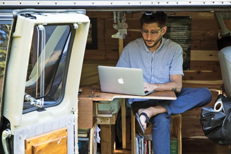 In this 2018, photo, U.S. journalist Danny Fenster works out of his van that he made into a home/office in Detroit. Fenster, who has spent more than four months in pretrial detention in military-ruled Myanmar has been slapped with a second criminal charge of violating section of the Unlawful Associations Act his lawyer said on October 4, 2021. (AP File Photo)