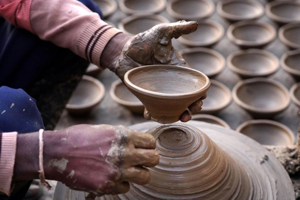 Ajmer: A potter moulds an earthen lamp (Diya) on a wheel, ahead of the Diwali festival, in Ajmer, Friday, Oct. 29, 2021. (PTI Photo)(