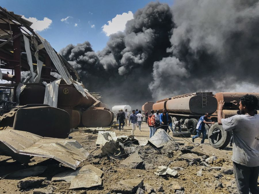 Mekele: People are seen in front of clouds of black smoke from fires in the aftermath at the scene of an airstrike in Mekele, the capital of the Tigray region of northern Ethiopia Wednesday, Oct. 20, 2021. New airstrikes have hit Mekele, residents said Wednesday, as Ethiopia's government said it was targeting facilities to make and repair weapons, which a spokesman for the rival Tigray forces denied. AP/PTI