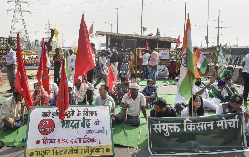 Farmers block a road during their 'Bharat Bandh' against central government's three farm reform laws, at Ghazipur border in New Delhi on September 27, 2021. (PTI File Photo)