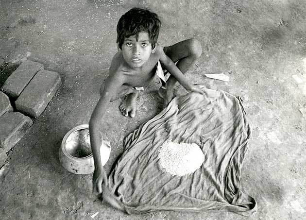 Collecting her WFP ration from an NGO centre in Bangladesh. Vulnerable group feeding, with development aspects progressively added, has provided a safety net for millions of poor, malnourished Bangladeshis for decades. (Trevor Page Photo)