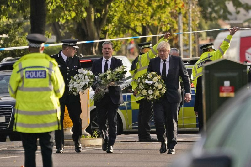 British Prime Minister Boris Johnson, right, and Leader of the Labour Party Sir Keir Starmer, second from right, carry flowers as they arrive at the scene where a member of Parliament was stabbed Friday, in Leigh-on-Sea, Essex, England, Saturday, October. 16, 2021. (AP/PTI Photo)