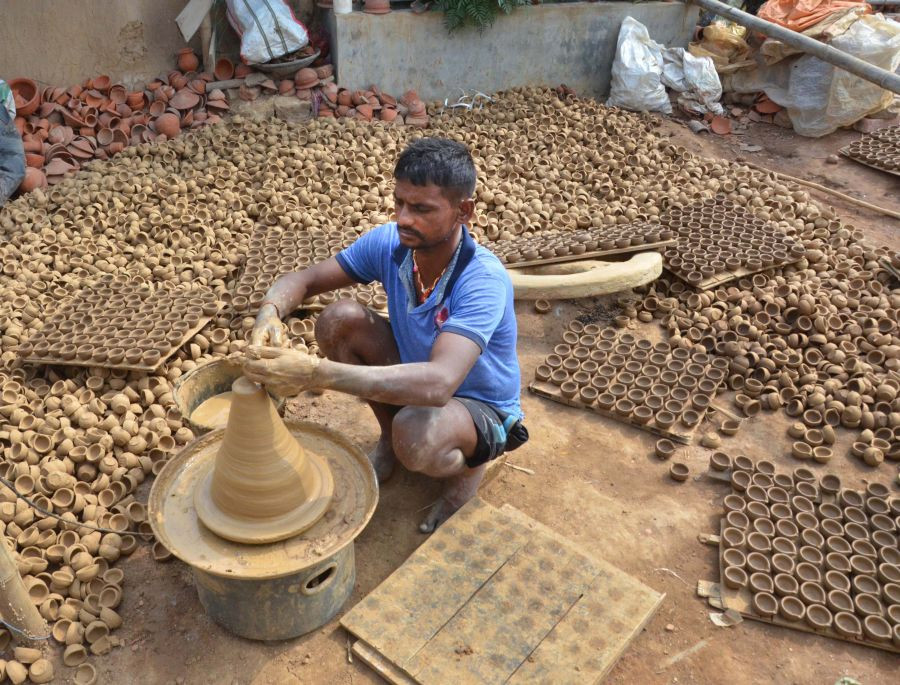 Ranchi: A potter makes earthen lamps for sale ahead of the Diwali festival, in Ranchi, Tuesday, Oct. 26, 2021. (PTI Photo)