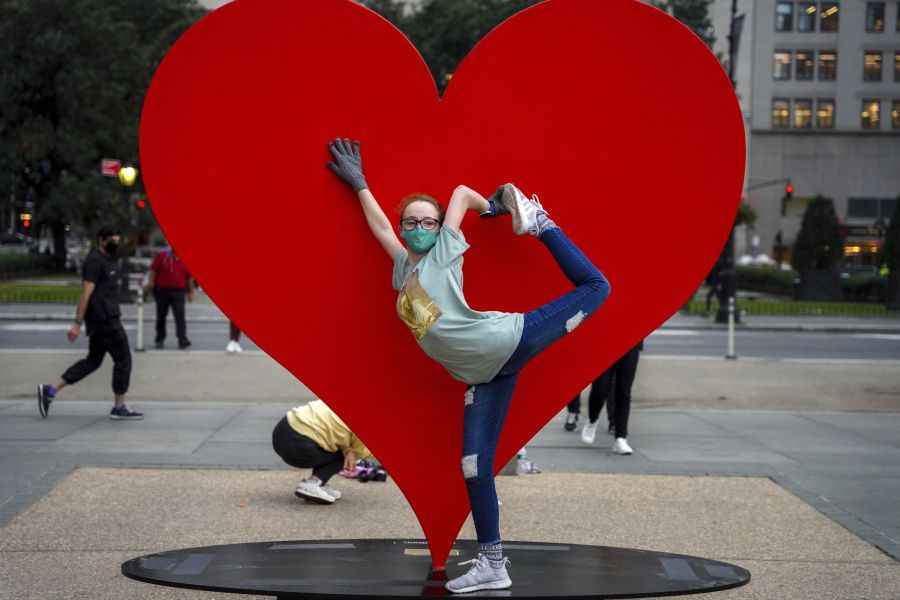New York: Jada Cathcart, 16, poses for a picture in front of "The Hero Monument" sculpture made by Italian sculptor Sergio Furnari, a symbol of hope and love dedicated to health care workers around the world, Monday, Oct. 25, 2021, in Manhattan's Grand Army Plaza in New York.AP/PTI Photo