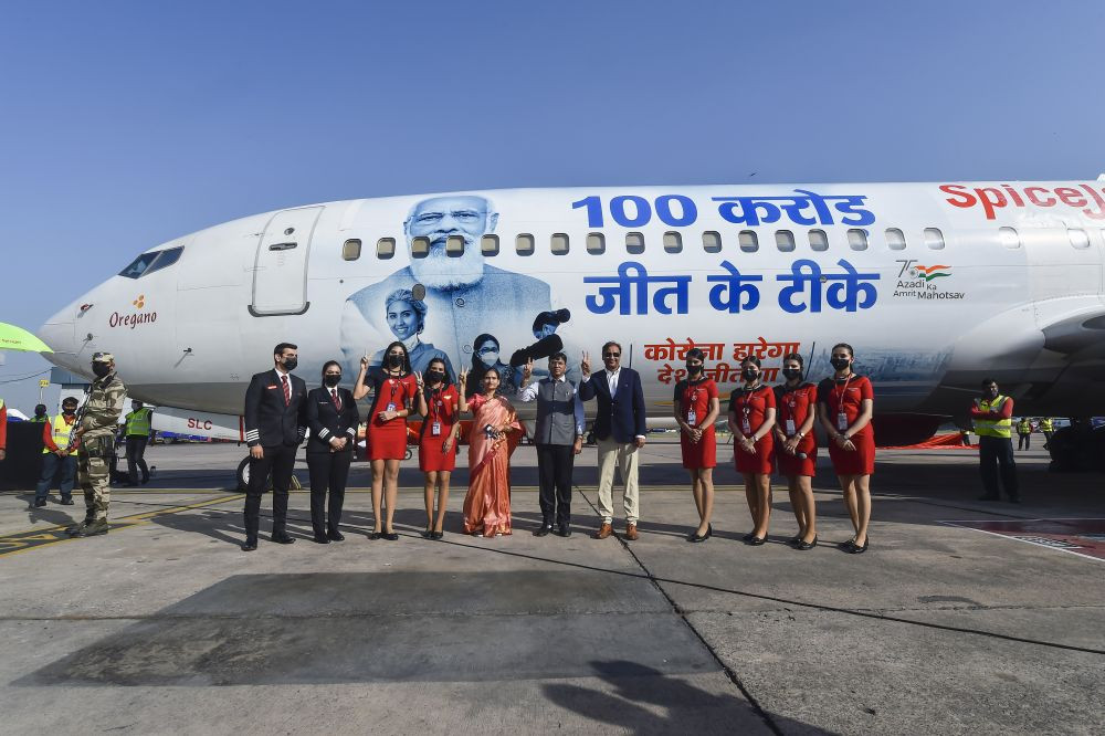 New Delhi: Union Health Minister Mansukh Mandaviya and SpiceJet CMD Ajay Singh during unveiling of special aircraft fleet with images of Prime Minister Narendra Modi and healthcare workers,  as India crossed the 1 billion Covid-19 vaccine dose milestone, at IGI Airport  in New Delhi, Thursday, Oct. 21, 2021. (PTI Photo/Kamal Singh)
