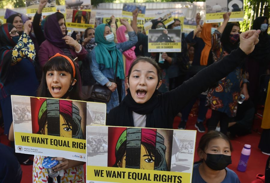 New Delhi: Girls hold posters and raise slogans during a sit-in protest by Afghan Refugee Women Association against the violence against women in Afghanistan, at Jantar Mantar in New Delhi, Saturday, Oct. 30, 2021. (PTI Photo/Manvender Vashist)