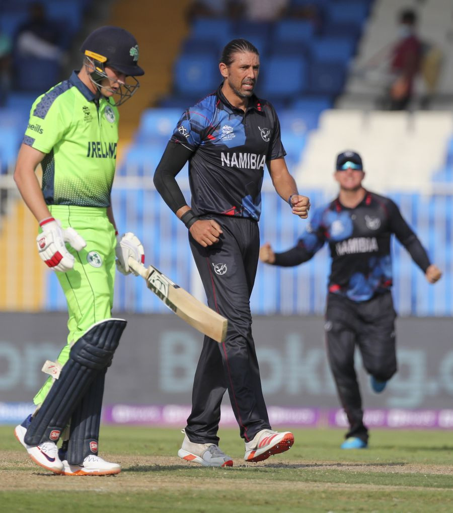 Sharjah: Namibia's David Wiese, centre, celebrates after taking the wicket of Ireland's Harry Tector, left, during the Cricket Twenty20 World Cup first round match between Namibia and Ireland in Sharjah, UAE, Friday, Oct. 22, 2021. AP/PTI(AP10_22_2021_000147B)