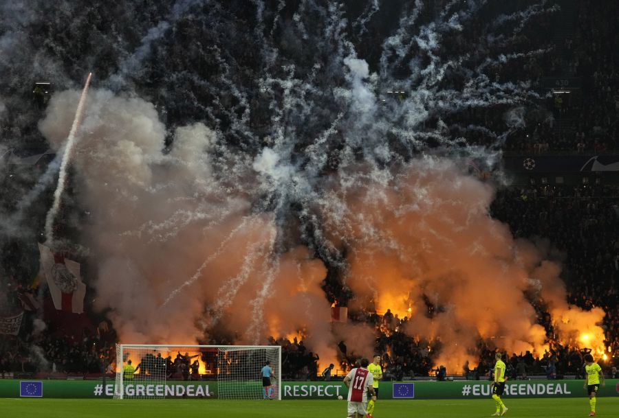 Amsterdam : Ajax fans light fireworks during the Champions League group C soccer match between Ajax and Borussia Dortmund at the Johan Cruyff ArenA in Amsterdam, Netherlands, Tuesday, Oct. 19, 2021. AP/PTI