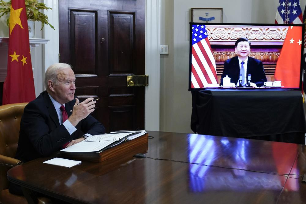 President Joe Biden meets virtually with Chinese President Xi Jinping from the Roosevelt Room of the White House in Washington, Monday, Nov. 15, 2021. (AP Photo)