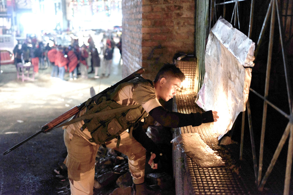 IN SOLIDARITY: A man lights a candle during the candlelight vigil service organised by Angami Public Organisation in Kohima on December 6. (Photo Courtesy: Seyie Suohu)