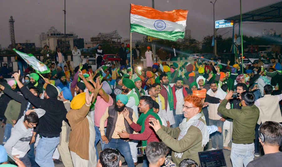 Farmers dance as they celebrate at the Ghazipur border after a decision to withdraw farmers-movement in the wake of the government accepting all demands put forward by the agitating farmers, in Ghaziabad, on December 10. (PTI Photo)