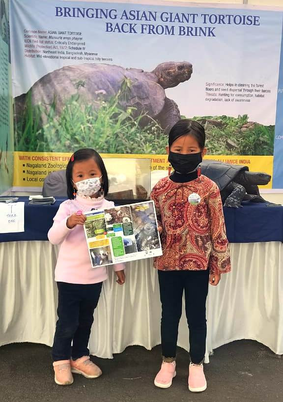 Two young visitors at the stall in Kisama.