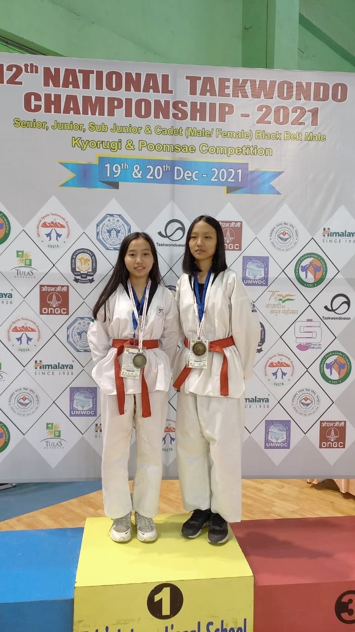 Likuta P Tissica (under 41 kg) and Likupu Swu (under 44 kg) Grade IX girls from Hollotoli School won Gold Medals in the respective categories at the 12th National Taekwondo Championship. Deepak Kumar Prasad, the team coach also won Gold Medal in Poomse (under age 40 category). The Championship was held at Maharana Pratap Sports College, Raipur Dehradun on December 19 and 20. Altogether 800 participants from 16 Indian States took part in the Championship. (Photo Courtesy: Hollotoli School)