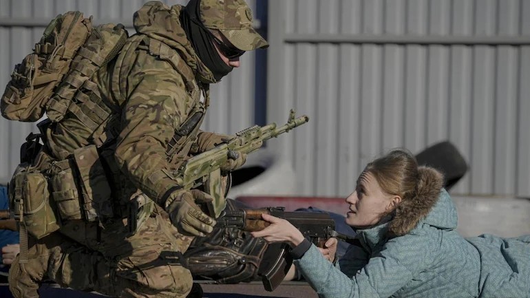 A young woman holds a weapon during a basic combat training for civilians organised by the Special Forces Unit, Azov, of Ukraine's National Guard in Mariupol, Donetsk region, eastern Ukraine on Sunday, February 13. The United States is evacuating almost all of the staff from its embassy in Kyiv as Western intelligence officials warned that a Russian invasion of Ukraine is imminent. (AP/PTI Photo)