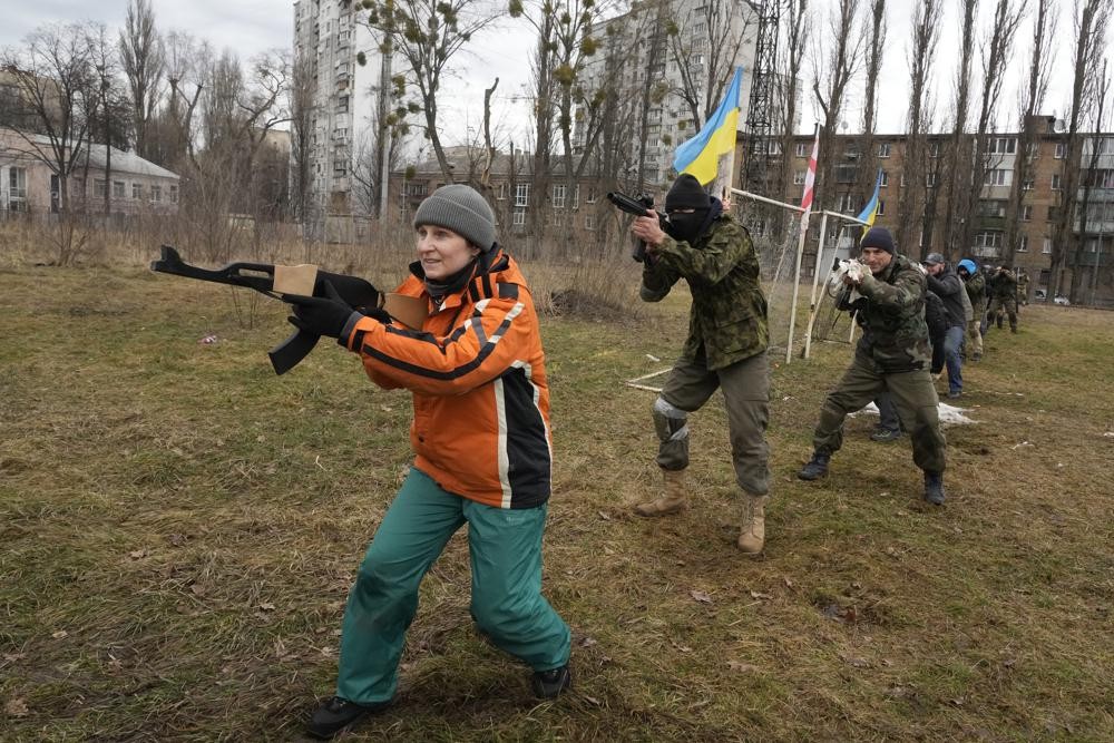 Civilians train with members of the Georgian Legion, a paramilitary unit formed mainly by ethnic Georgian volunteers to fight against Russian forces in Ukraine in 2014, in Kyiv, Ukraine, Saturday, Feb. 19, 2022. Separatist leaders in eastern Ukraine have ordered a full military mobilization amid growing fears in the West that Russia is planning to invade the neighboring country. The announcement on Saturday came amid a spike in violence along the line of contact between Ukrainian forces and the pro-Russia rebels in recent days. (AP Photo/Efrem Lukatsky)