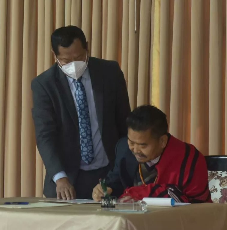 YM Yollow Konyak signing a document during the swearing-in ceremony held at Raj Bhavan, Kohima on February 9. (Photo courtesy: Twitter)