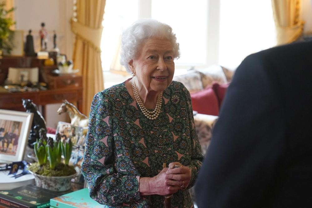 FILE - Queen Elizabeth II speaks during an audience at Windsor Castle where she met the incoming and outgoing Defence Service Secretaries, Wednesday Feb. 16, 2022. Buckingham Palace said Sunday, Feb. 20, 2022 that Queen Elizabeth II tested positive for COVID-19, has mild symptoms and will continue with duties. (Steve Parsons, Pool via AP, File)