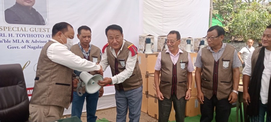 Advisor Tovihoto Ayemi distributing megaphones to urban colony councils on March 8.