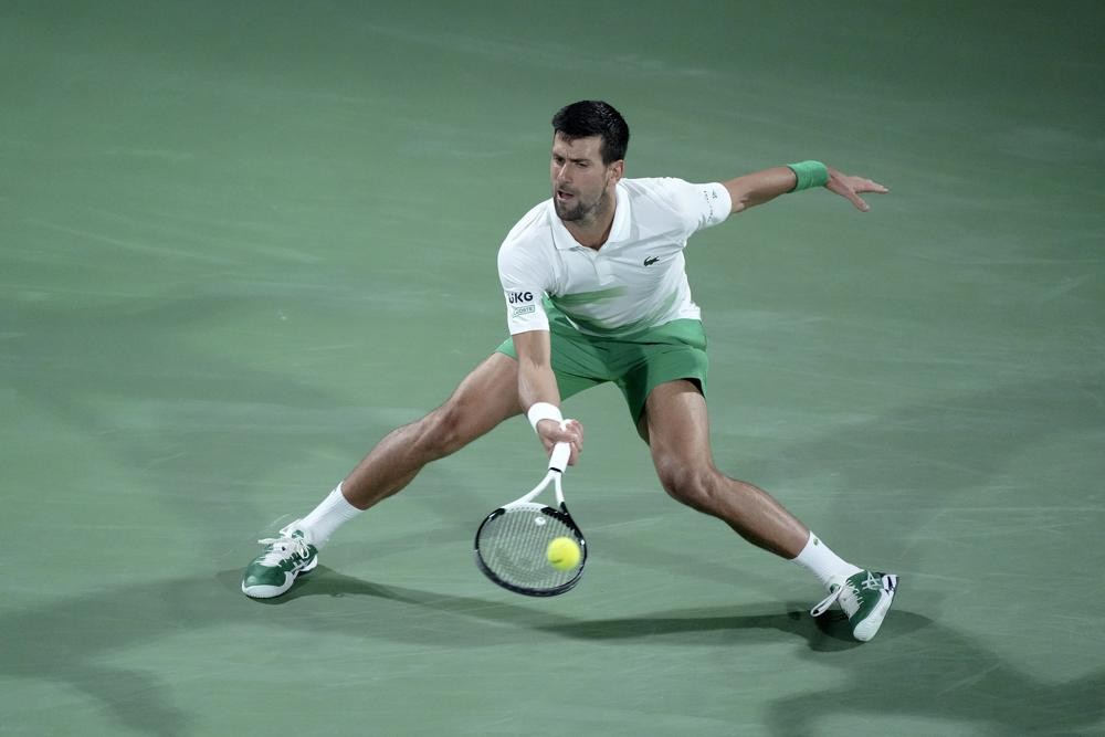 Serbia's Novak Djokovic returns the ball to Czech Republic's Jiri Vesely during a match at the Dubai Duty Free Tennis Championship in Dubai, United Arab Emirates, Thursday, Feb. 24, 2022. (AP Photo/Ebrahim Noroozi)