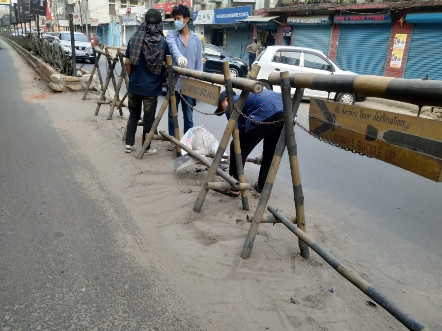 Student volunteers cleaning a portion of the road near City Tower junction on March 18. (Morung Photo)