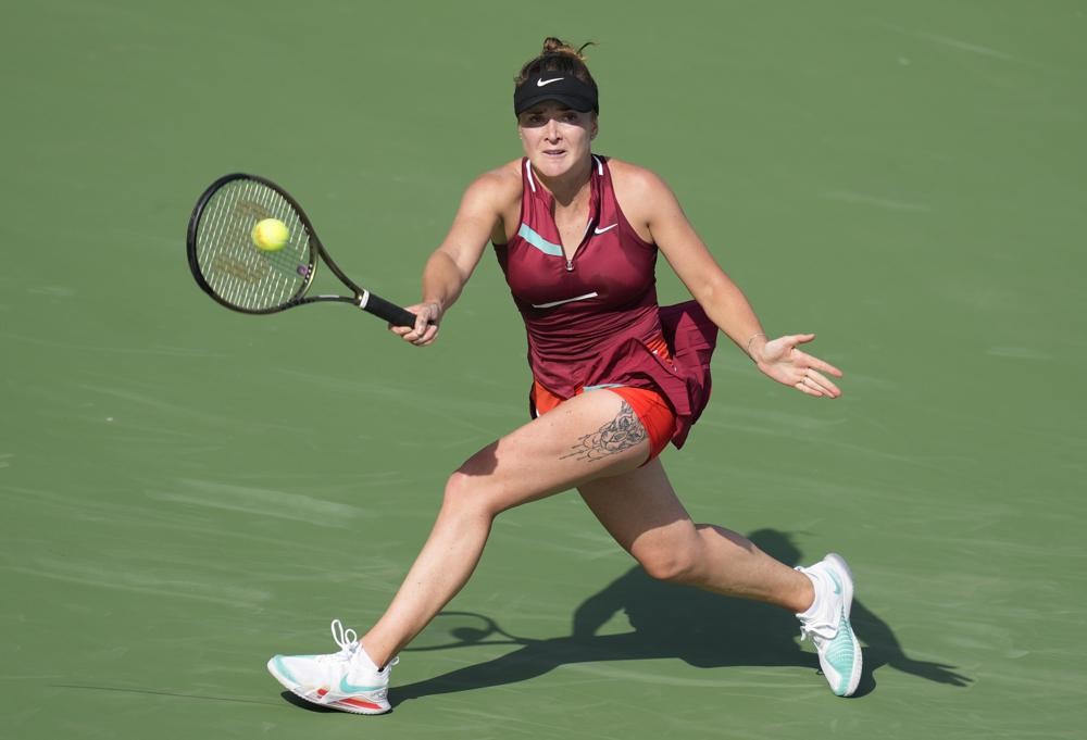 Elina Svitolina of Ukraine returns the ball to Mayar Sherif of Egypt during a match of the Dubai Duty Free Tennis Championship in Dubai, United Arab Emirates, Tuesday, Feb. 15, 2022. (AP Photo)