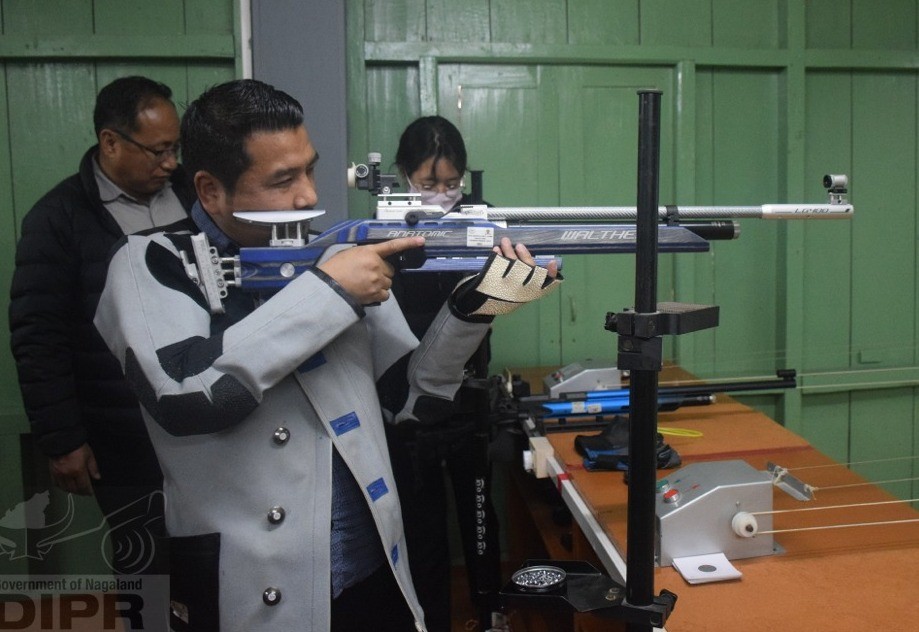 Tongpang Ozukum trying out his shooting skills after inaugurating the Khelo India Centre (Shooting) at Ladybird school, Mokokchung on April 19. (DIPR Photo)