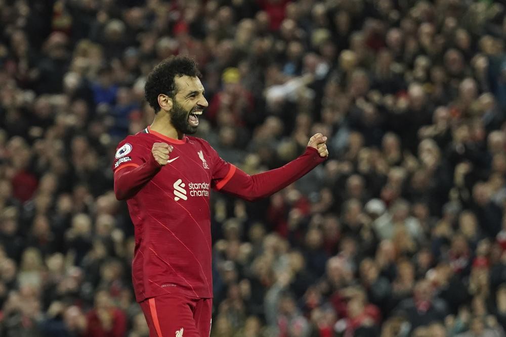 Liverpool's Mohamed Salah celebrates after scoring his side's fourth goal during the English Premier League soccer match between Liverpool and Manchester United at Anfield stadium in Liverpool, England, Tuesday, April 19, 2022. (AP Photo/Jon Super)