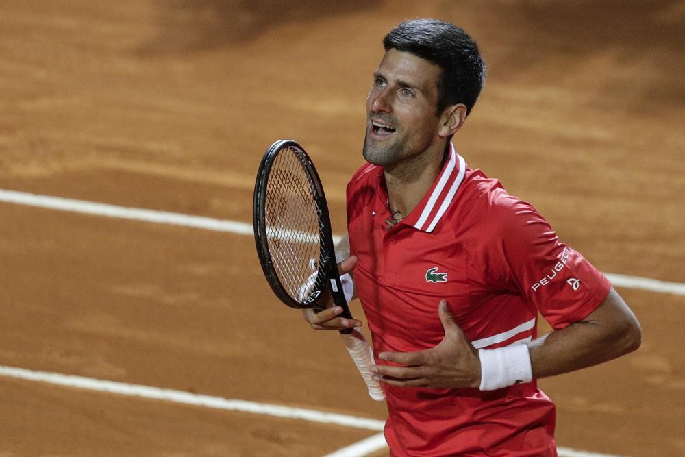 FILE - Serbia's Novak Djokovic celebrates after defeating Italy's Lorenzo Sonego in their semifinal match at the Italian Open tennis tournament, in Rome, May 15, 2021. Djokovic won 6-3 6-7 6-2 and will play Rafael Nadal in the final. Novak Djokovic is ready to move on from the controversy surrounding his refusal to get vaccinated against COVID-19. “I miss competition,” the Serbian tennis star said Sunday April 10, 2022, on the opening day of the clay-court season at the Monte Carlo Masters in Monaco. (AP Photo/Gregorio Borgia, File)