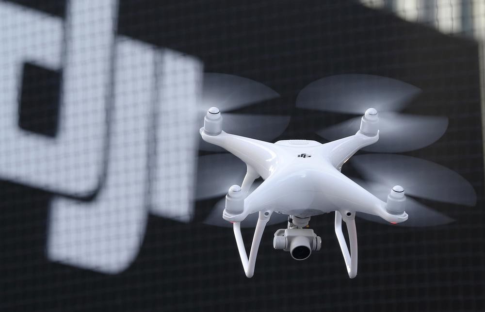 FILE - A Phantom 4, developed by major Chinese consumer-drone maker DJI, flies during its demonstration flight in Tokyo, Thursday, March 3, 2016. Drone company DJI Technology Co said Tuesday, April 27, 2022, that it has temporarily suspended business activities in Russia and Ukraine to prevent use of its drones in combat, in a rare case of a Chinese company pulling out of Russia. (AP Photo/Shizuo Kambayashi, File)