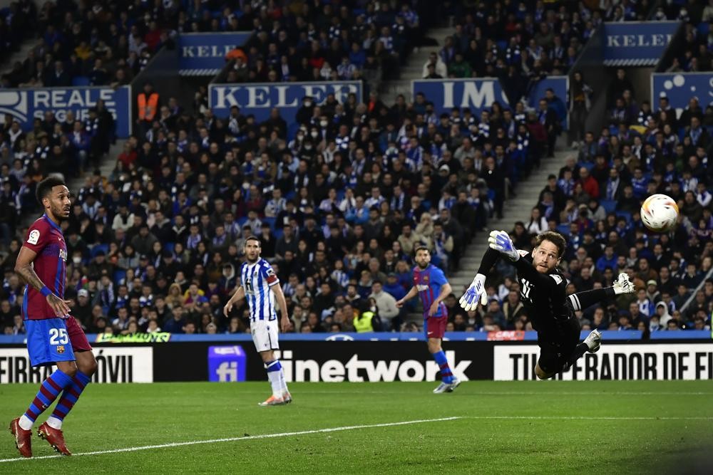 Barcelona's Pierre-Emerick Aubameyang, left, tries to score next to Real Sociedad's goalkeeper Alex Remiro during a Spanish La Liga soccer match between Real Sociedad and FC Barcelona at the Reale Arena stadium in San Sebastian, Spain on April 21. (AP Photo/Alvaro Barrientos)