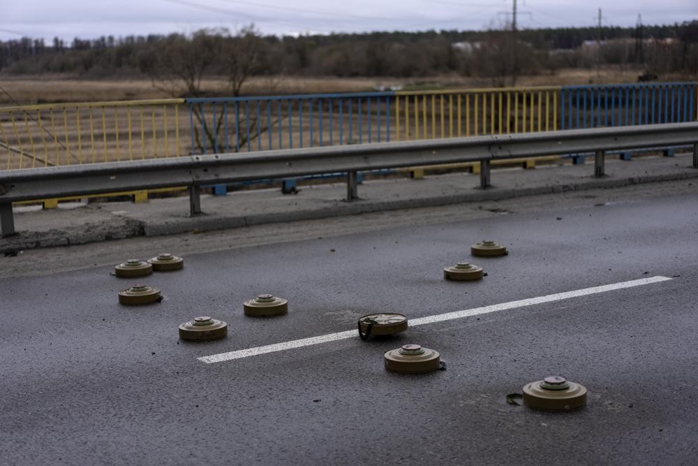 Anti tank mines are displayed on a bridge in Bucha, in the outskirts of Kyiv, Ukraine, Saturday, April 2, 2022. (AP Photo/Rodrigo Abd)