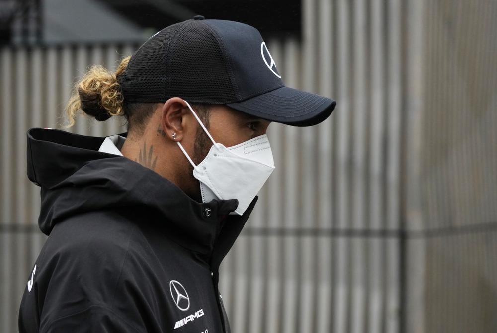 Mercedes driver Lewis Hamilton of Britain arrives in the paddock at the Dino and Enzo Ferrari racetrack, in Imola, Italy, Thursday, April 21, 2022. Italy's Emila Romagna Formula One Grand Prix will take place on Sunday. (AP Photo/Luca Bruno)