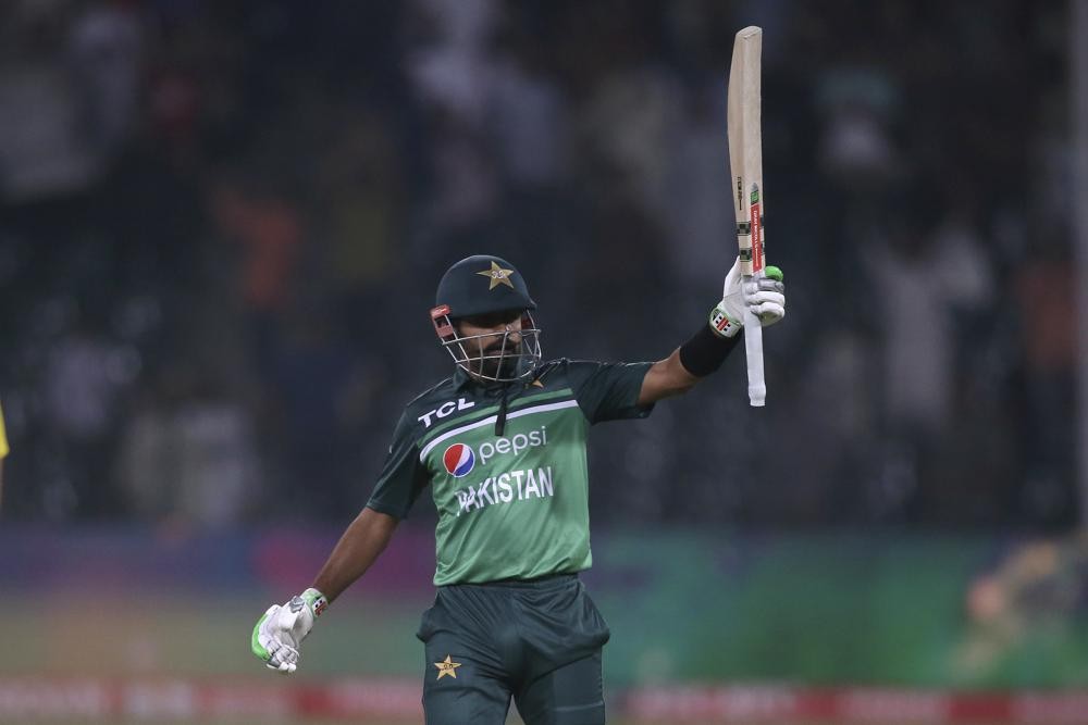 Pakistan's Babar Azam celebrates after his century during the second one day international cricket match between Pakistan and Australia at Gaddafi Stadium in Lahore, Pakistan, Thursday, March 31, 2022. (AP Photo/K.M. Chaudary)