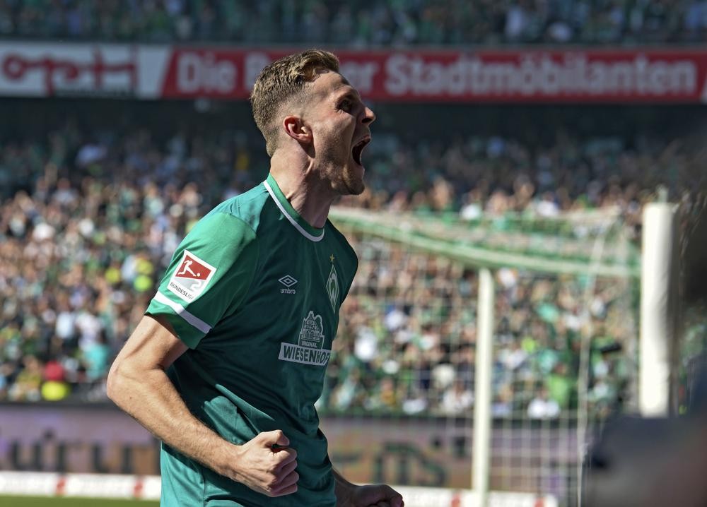 Werder's Marvin Ducksch celebrates his goal during the 2nd Bundesliga soccer match between Werder Bremen and Jahn Regensburg, in Bremen, Germany, Sunday, May 15, 2022. Werder Bremen has secured promotion back to the Bundesliga along with Schalke thanks to a 2-0 win over Jahn Regensburg in Germany’s second division. (Carmen Jaspersen/dpa via AP)
