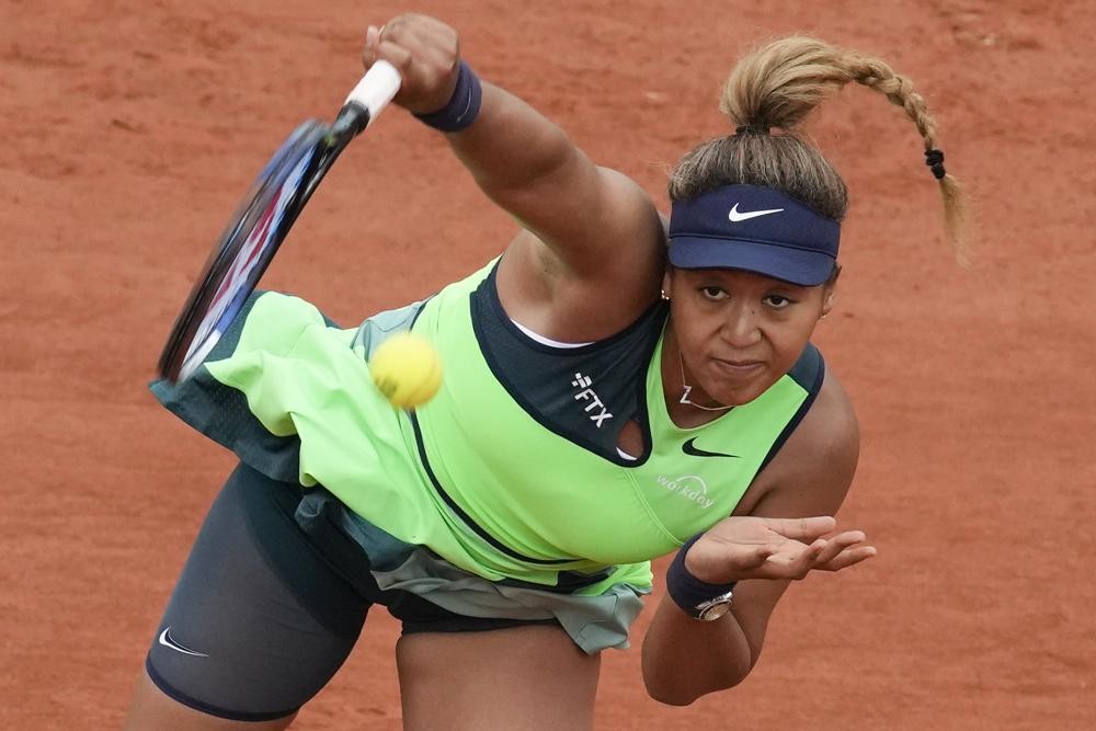 FILE - Japan's Naomi Osaka serves against Amanda Anisimova of the U.S. during their first round match at the French Open tennis tournament in Roland Garros stadium in Paris, France, Monday, May 23, 2022. Naomi Osaka's 2022 French Open is done following a first-round loss. The players remaining in the tournament see and hear products of her frank discussion about anxiety and depression a year ago -- from new "quiet rooms" and on-call psychiatrists at Roland Garros to a broader sense that mental health is a far-less-taboo topic than it once was. (AP Photo/Christophe Ena, File)