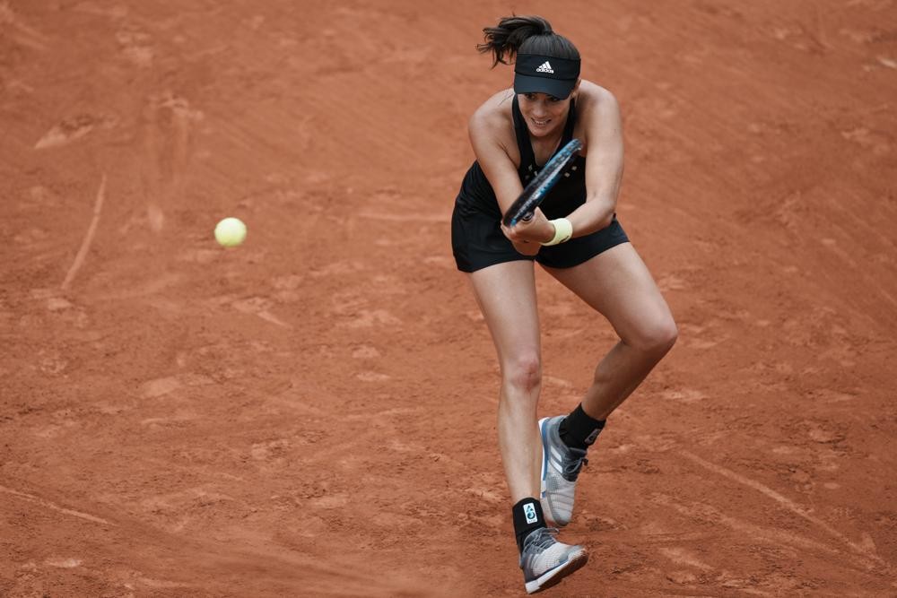 Spain's Garbine Muguruza plays a shot against Estonia's Kaia Kanepi during their first round match at the French Open tennis tournament in Roland Garros stadium in Paris, France, Sunday, May 22, 2022. (AP Photo/Thibault Camus)