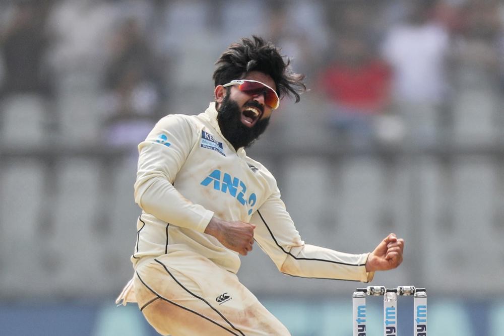 FILE - New Zealand's Ajaz Patel celebrates the dismissal of India's Mohammed Siraj during day two of their second test cricket match against India in Mumbai, India, Dec. 4, 2021. Patel, who is one of only three players to have taken 10 wickets in a test innings, will return to the New Zealand cricket team for its three-test tour to England in June 2022. (AP Photo/Rafiq Maqbool, File)