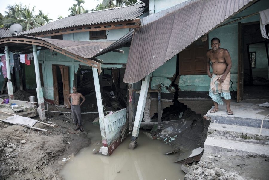 Residents at their damaged house during floods, in Bajali district, Friday, June 24, 2022. (PTI Photo)