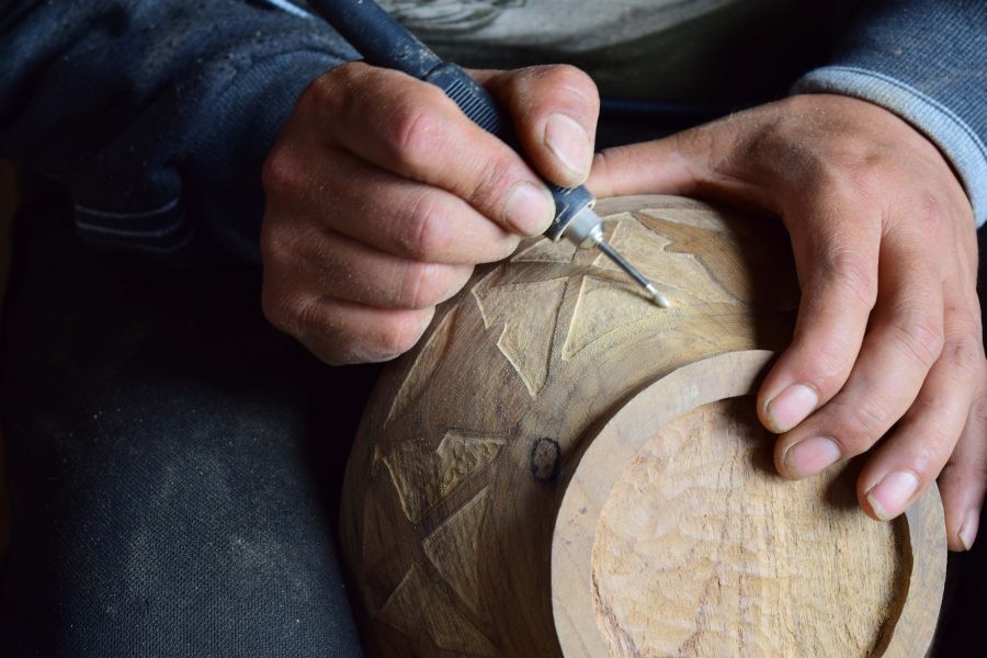 Artisans at work with products at various stages of development.