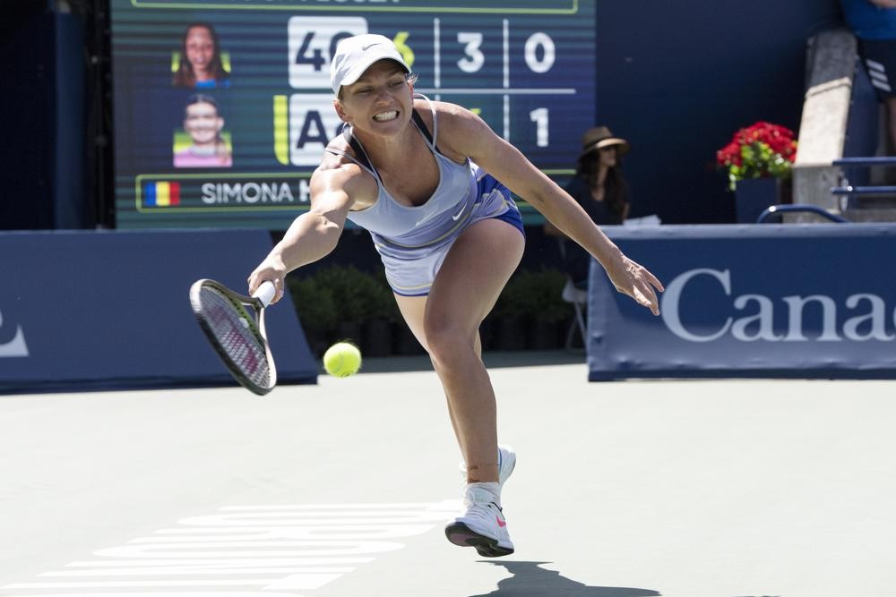 Romania's Simona Halep reaches for a return to United States' Jessica Pegula during the women's National Bank Open semifinal tennis match in Toronto, Saturday, Aug. 13, 2022. (Chris Young/The Canadian Press via AP)