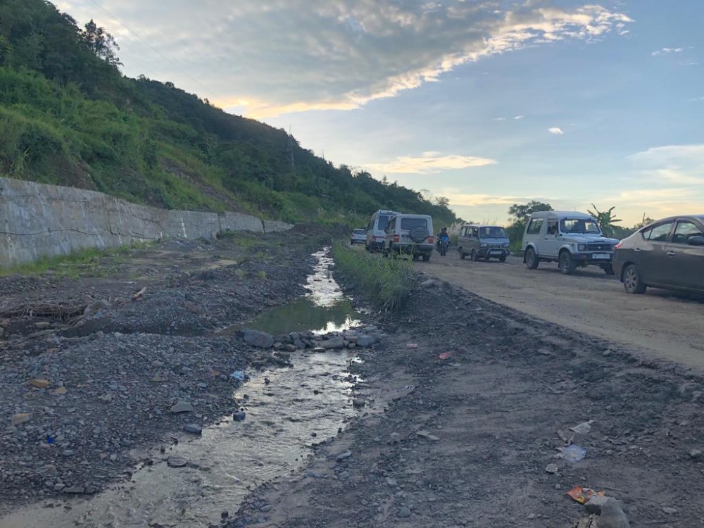 In this picture taken on October 6, vehicles ply on one-side of the ongoing NH 29 four-lane construction near Peducha, while a small rivulet is formed on the other side. (Morung Photo)