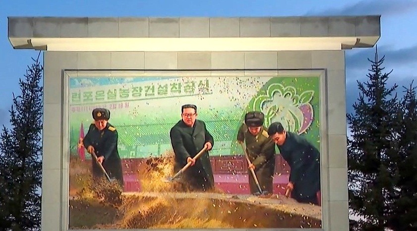 This photo, captured from footage from North Korea's state-run TV station on Oct. 11, 2022, shows the installment of a mosaic mural of North Korean leader Kim Jong-un that depicts him shoveling earth at a ceremony to mark the start of the construction of Ryonpho Greenhouse Farm in the nation's eastern province in February.(Yonhap/IANS)