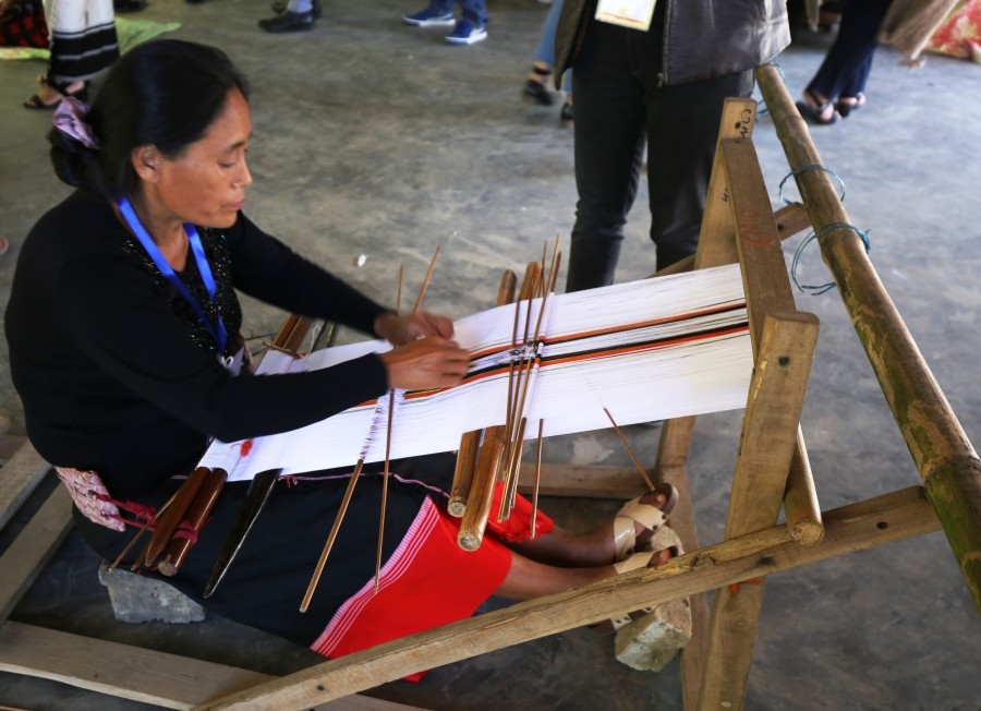 A weaver showcases her skill during the 8th International Loinloom Festival at the Weaver’s Place, Diezephe Handicrafts village, Chümoukedima on December 7. (Morung Photo)