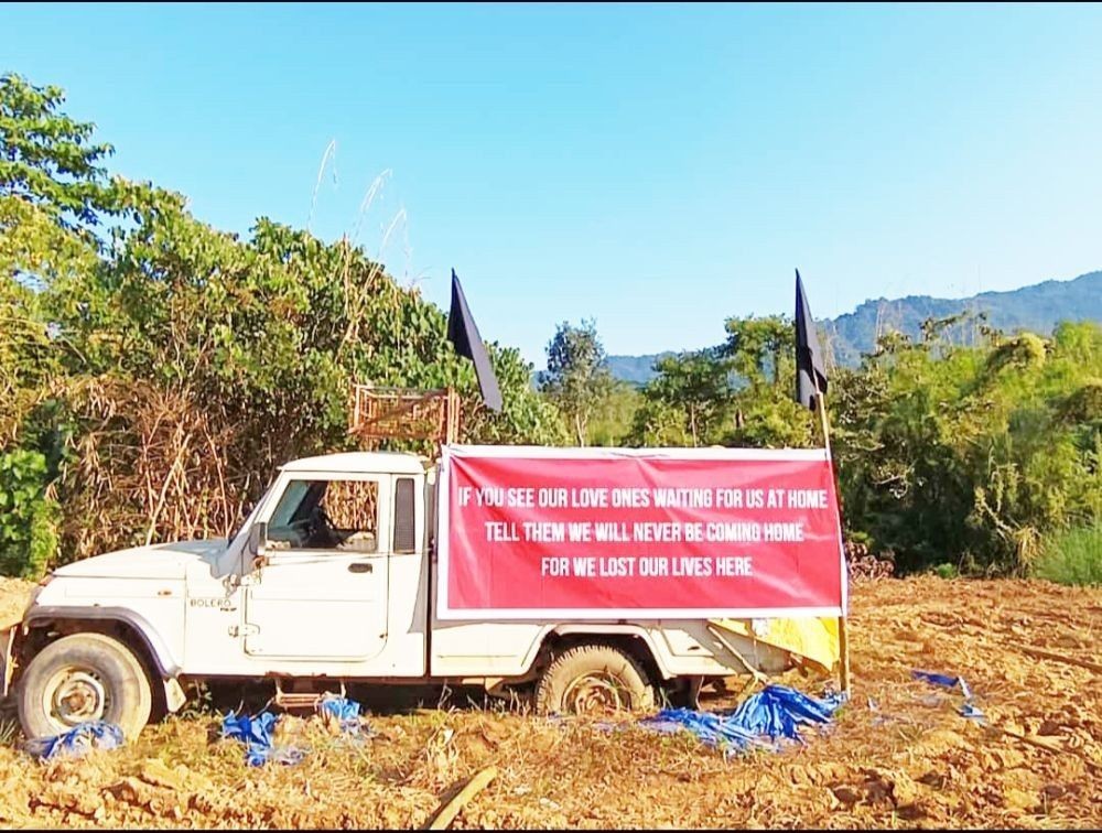 The Bolero pick-up carrying the eight coal miners riddled with bullets still stand at the site where six of them were killed on the spot on December 4, 2021. The site is at Yatong-Langkhao area under Oting village in Mon district. The banner put up by the Oting people on December 3 reads, “If you see our loved ones waiting for us at home, tell them we will never be coming home, for we lost our lives here.” The village will be observing Black Day in memory of the 14 innocent civilians killed on December 4 and 5, 2021 at Oting public ground on December 4. (Photo Courtesy: Mantong Konyak)