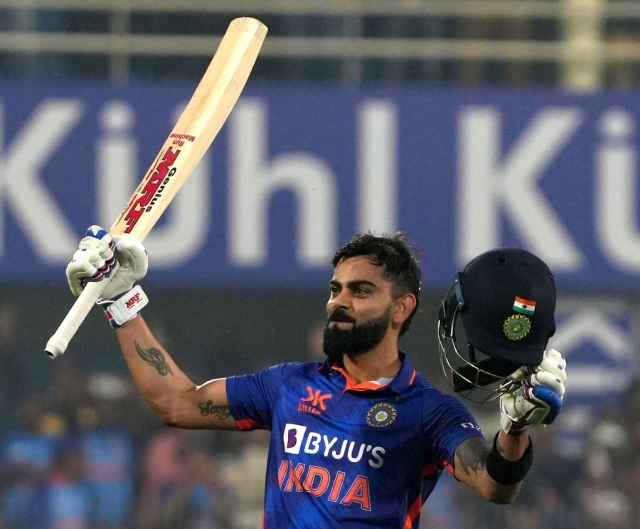 India's Virat Kohli rises his bat as he celebrates after scoring a century during the first one-day international cricket match between India and Sri Lanka in Guwahati on January 10. (Photo: Anuwar Hazarika/IANS)