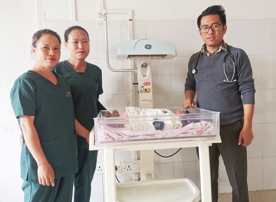 Dr Akumtoshi (Right) and the medical team with the baby.