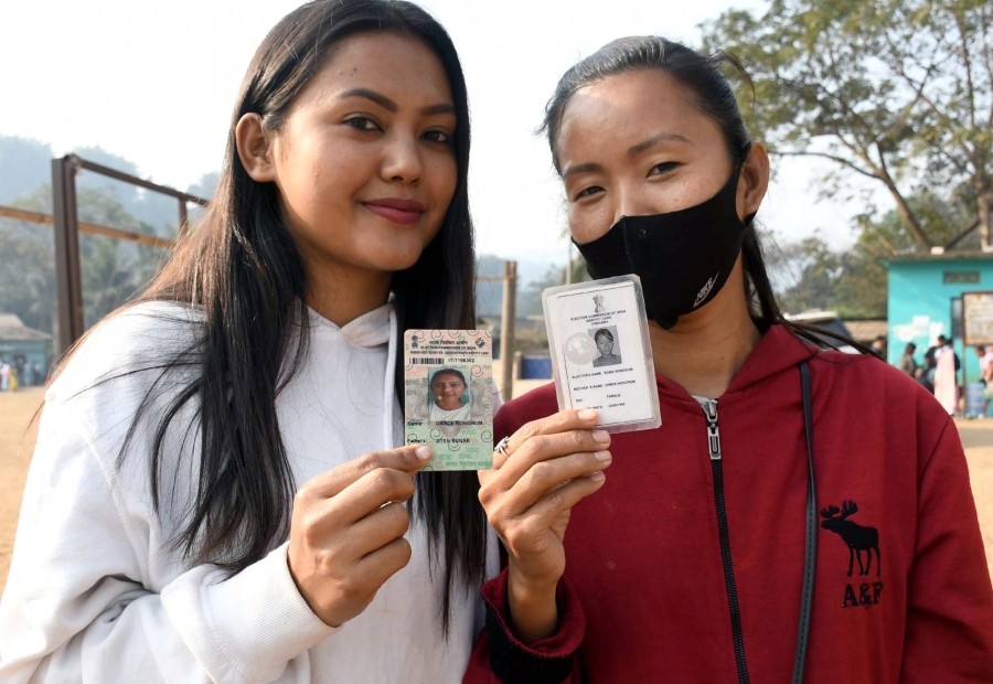 Ri Bhoi: Young voters show their ID cards before casting a vote at a polling station for the Meghalaya Assembly elections at Ri Bhoi district in Meghalaya on February 27. (Photo: Anuwar Hazarika/IANS)
