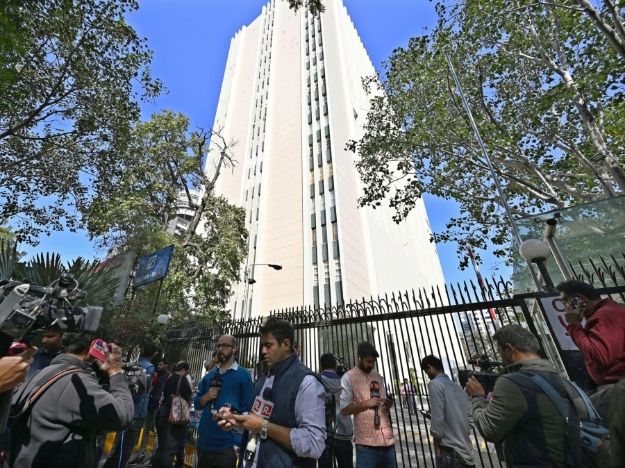 Media persons stand outside the office of BBC during a raid by the Income Tax authorities in New Delhi on  February 14. (IANS Photo)
